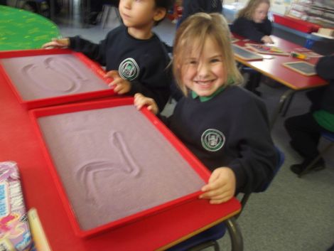 Practising numbers in the sand.