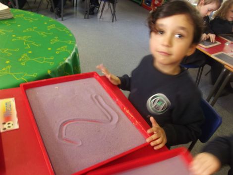 Practising numbers in the sand.