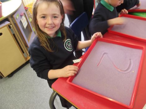 Practising numbers in the sand.