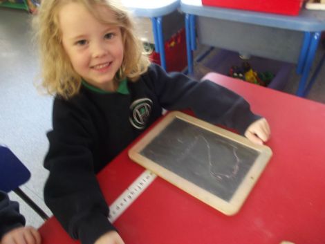 Practising numbers with chalk.