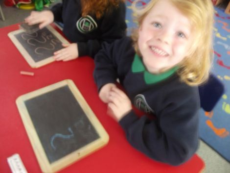 Practising numbers with chalk.
