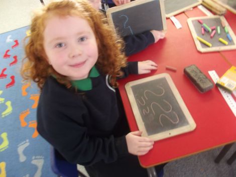 Practising numbers with chalk.