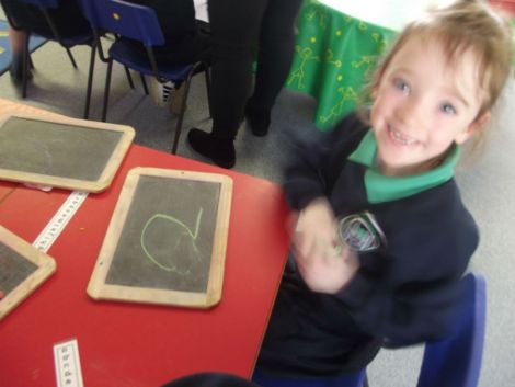 Practising numbers with chalk.