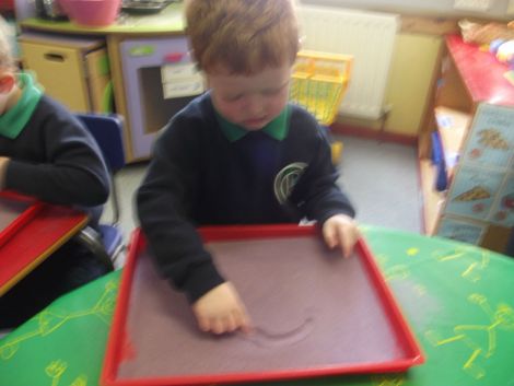 Practising numbers in the sand.