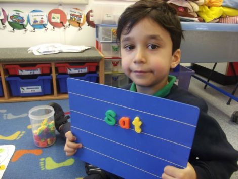 Using magnetic letters to make cvc words.