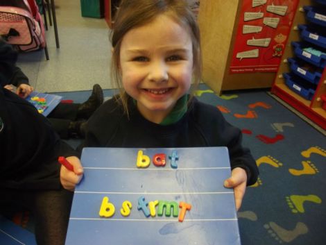 Using magnetic letters to make cvc words.