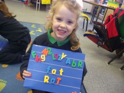 Using magnetic letters to make cvc words.