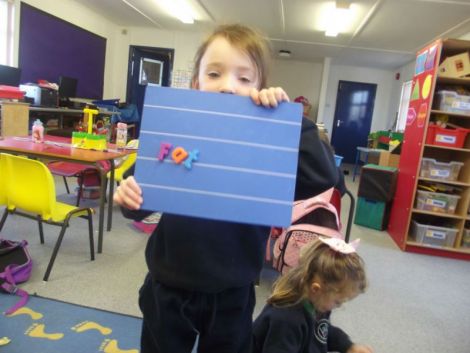 Using magnetic letters to make cvc words.