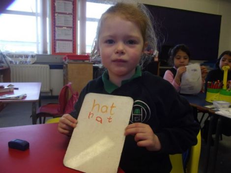 Using the whiteboards and markers to write some cvc words.