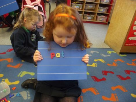 Using magnetic letters to make cvc words.
