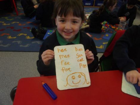 Using the whiteboards and markers to write some cvc words.