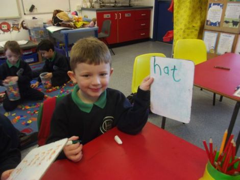 Using the whiteboards and markers to write some cvc words.